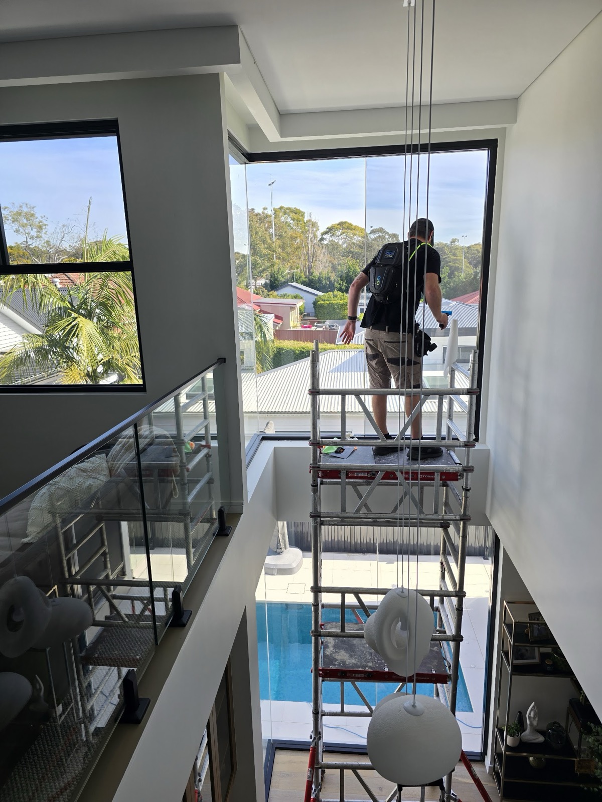 Installer working from a platform over a double-height void