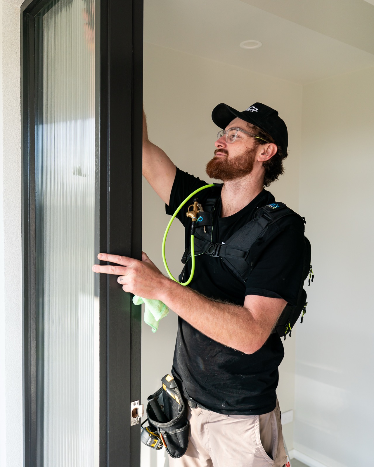 TintCo installer finishing a glass door panel